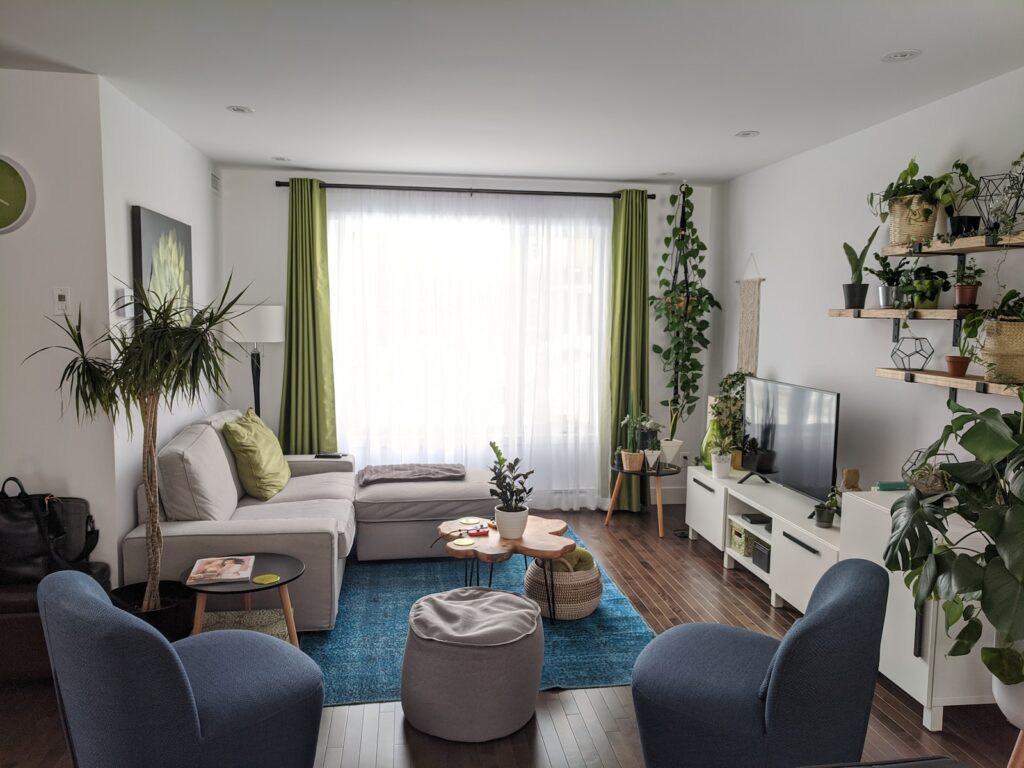 gray couch near white window curtain